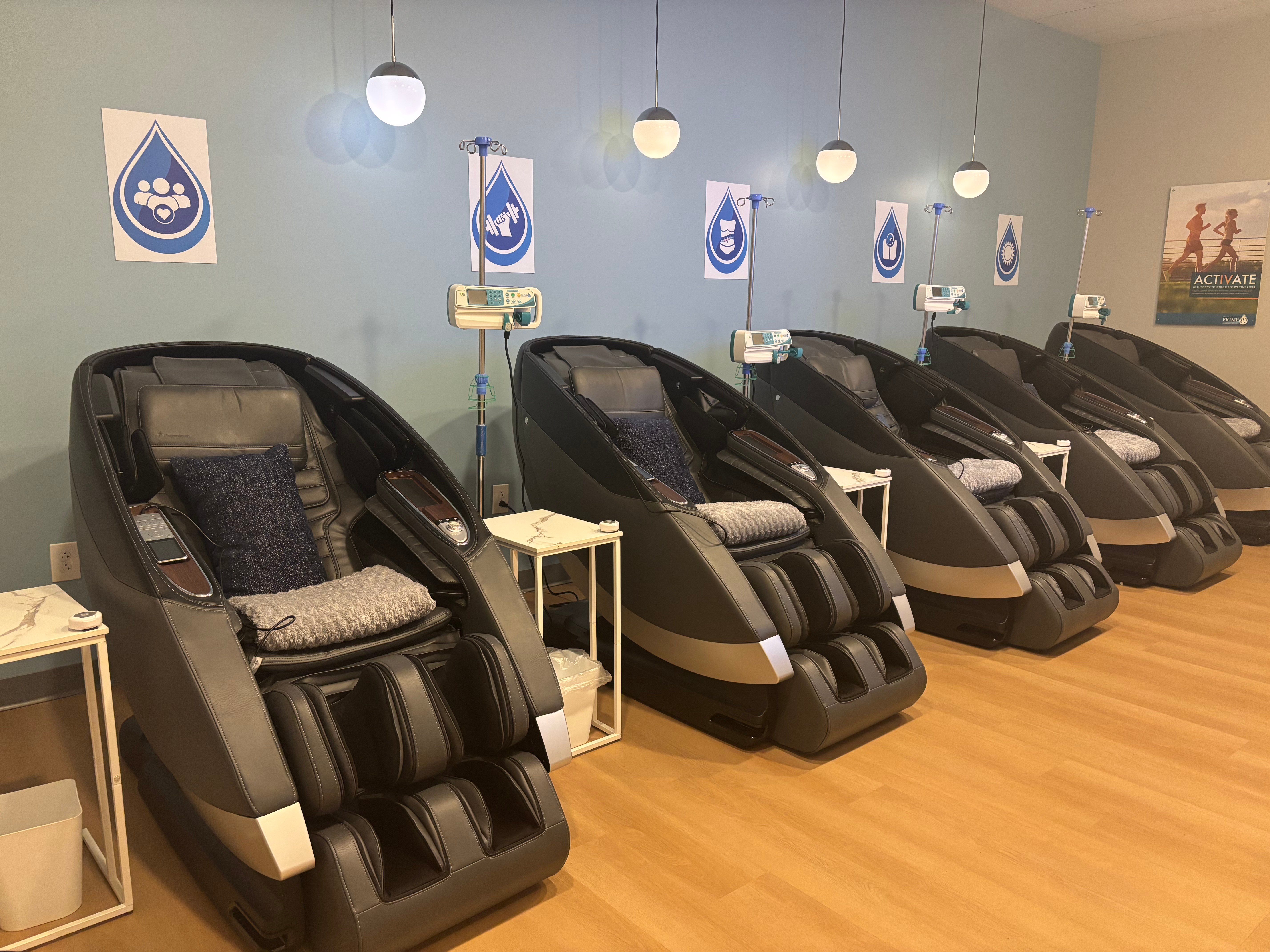 Rows of zero-gravity massage chairs and IV pumps in the Prime IV Nolensville lounge
